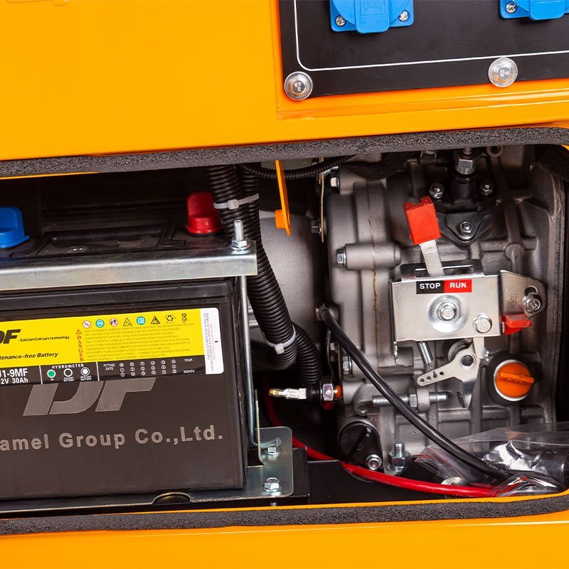 2026061002243045jpg pricemagicghcom Battery and engine compartment of an orange generator featuring a stoprun switch and exposed wiring
