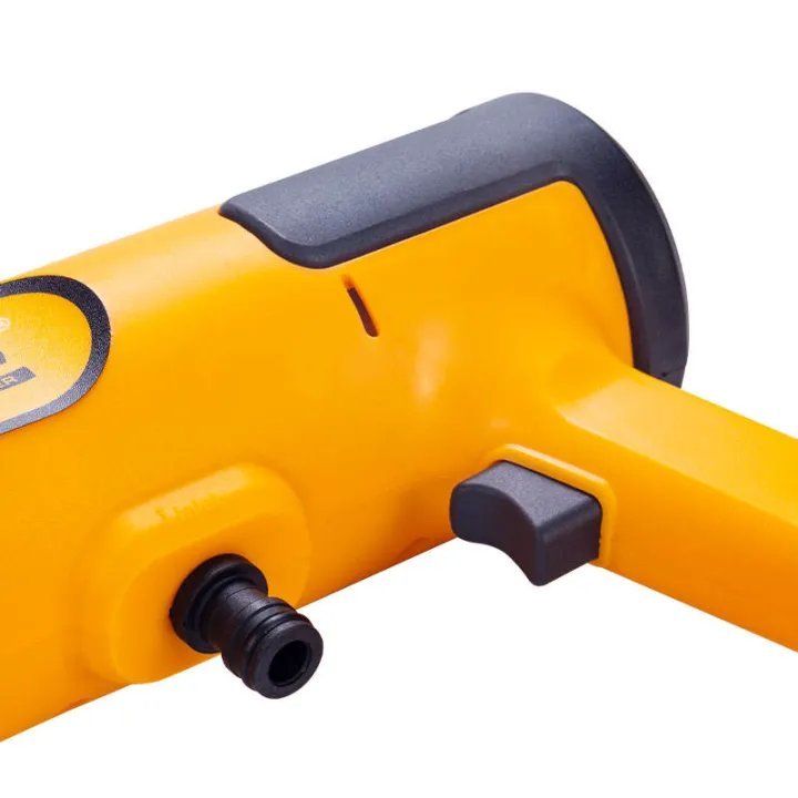 2026/06/1002281781.jpg - pricemagicgh.com Partial view of a yellow handheld power tool with a black grip and hose connector, likely a pneumatic hammer or drill.