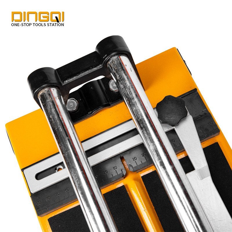 2026/06/1002853646.jpg - pricemagicgh.com Close-up of a yellow tile cutter with metal guide rails and a ruler, brand logo DINGQI in the top-left corner.