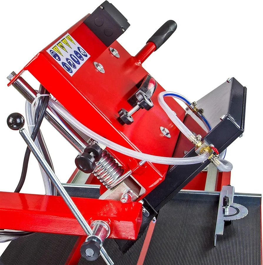 2026/06/1002880731.jpg - pricemagicgh.com Red industrial hydraulic tool mounted on a workbench, with a black handle, hoses, and metal clamps visible, used for pressing/bending operations on metalwork