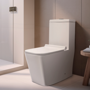 Modern white one-piece toilet in a contemporary bathroom with a glass shower enclosure and a wooden stool holding towels.