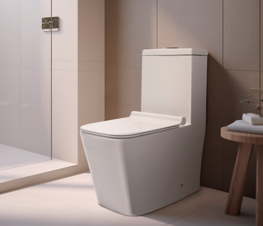 2026071003000652png pricemagicghcom Modern white one piece toilet in a contemporary bathroom with a glass shower enclosure and a wooden stool holding towels